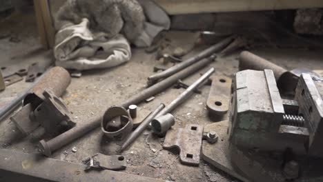 vintage bench vise and scrap metals in an old abandoned workshop