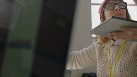 close-up-young-business-people-working-in-startup-office-caucasian-team-leader-man-pointing-at-tablet-computer-screen-showing-colleague-creative-ideas-training-intern-brainstorming-discussing-information