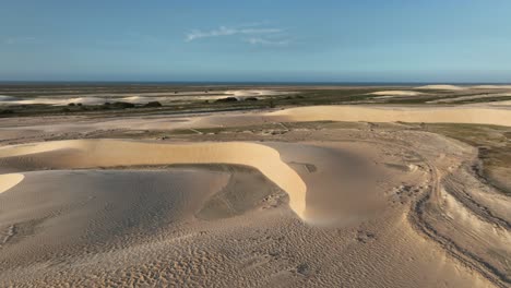 vast sand dunes stretch endlessly under the bright sky at lençóis maranhenses national park