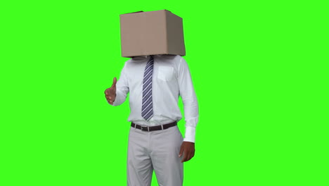 businessman with box over head shaking hand