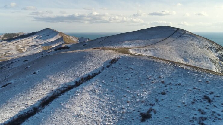 Snowy Mountain Peaks and Ocean View