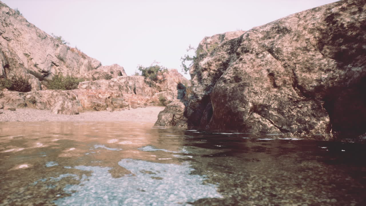 A tranquil river flows through a rocky valley