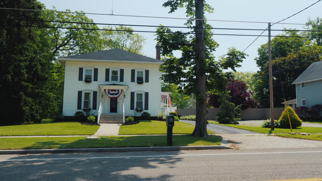 A Typical American Suburb Street Wooden White Houses And Manicured Lawns