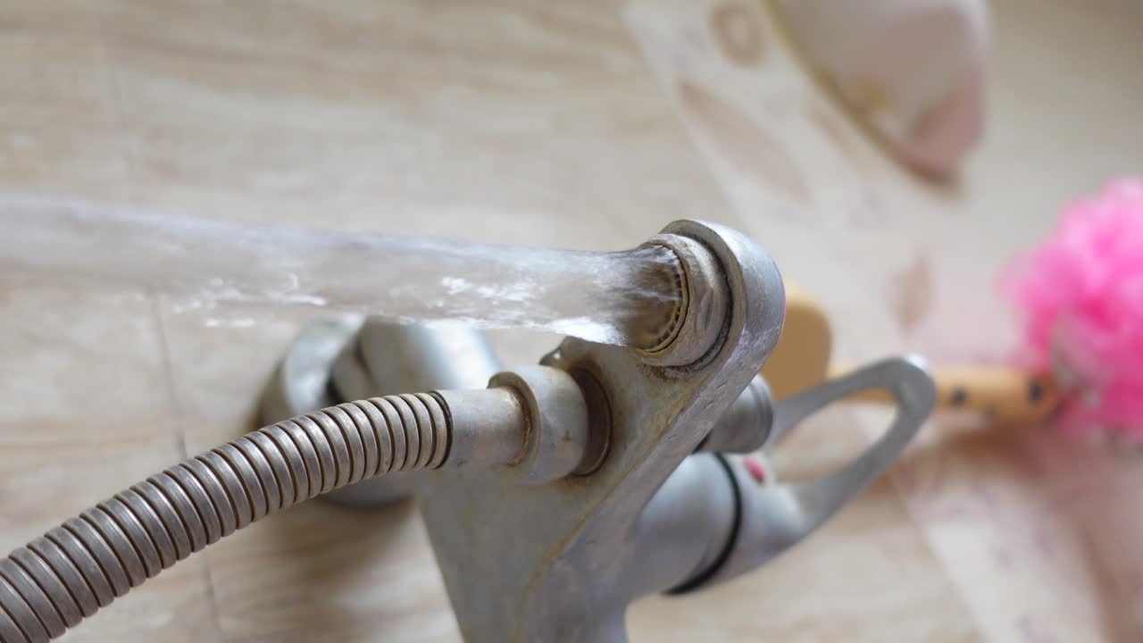 Water flowing from a shower faucet