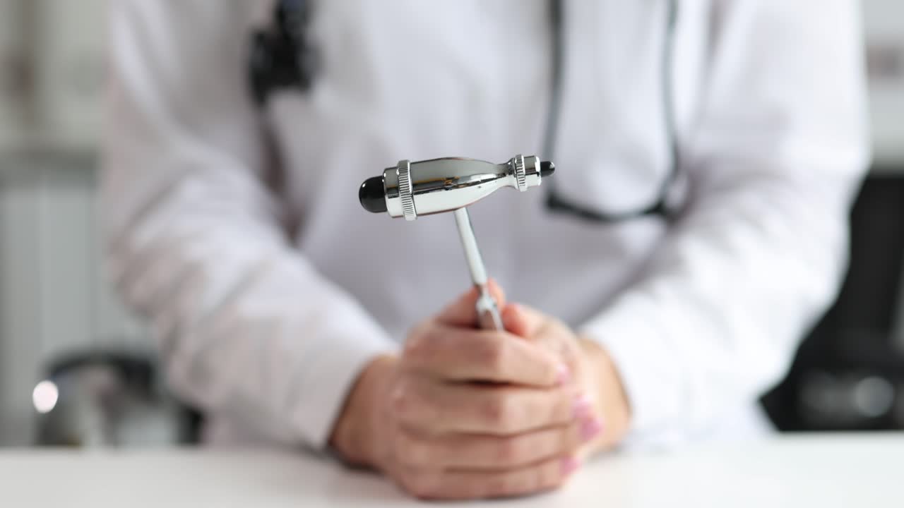Doctor holding a reflex hammer