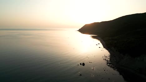 Beautiful-sunset-and-cliff-over-the-Adriatic-Sea,-aerial-view-from-a-drone