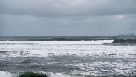 cold winter day in the arctic, crashing waves after a storm in north island - static slow motion shot