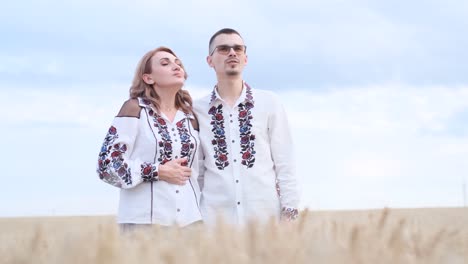 a beautiful ukrainian couple in embroidered shirts and with a flag in the middle of a wheat field a beautiful ukrainian couple in embroidered shirts and with a flag in the middle of a wheat field ukrainian patriots