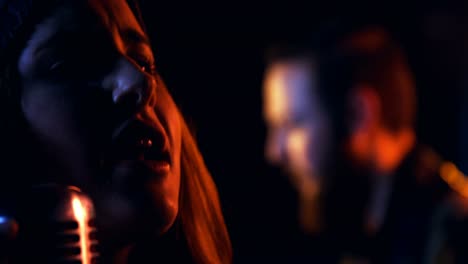 close-up of female singer singing in studio