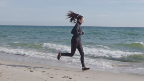 young woman exercising jogging outdoor running with ocean horizon on the beach