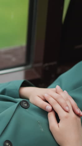 woman puts hands on stomach lying by window. businesswoman seeks moment of reprieve from day demands. everyday job pressures in leader position