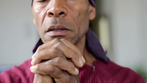 man praying to god with hands together caribbean man praying with background with people stock footage