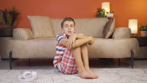 boy is afraid and worried at home.