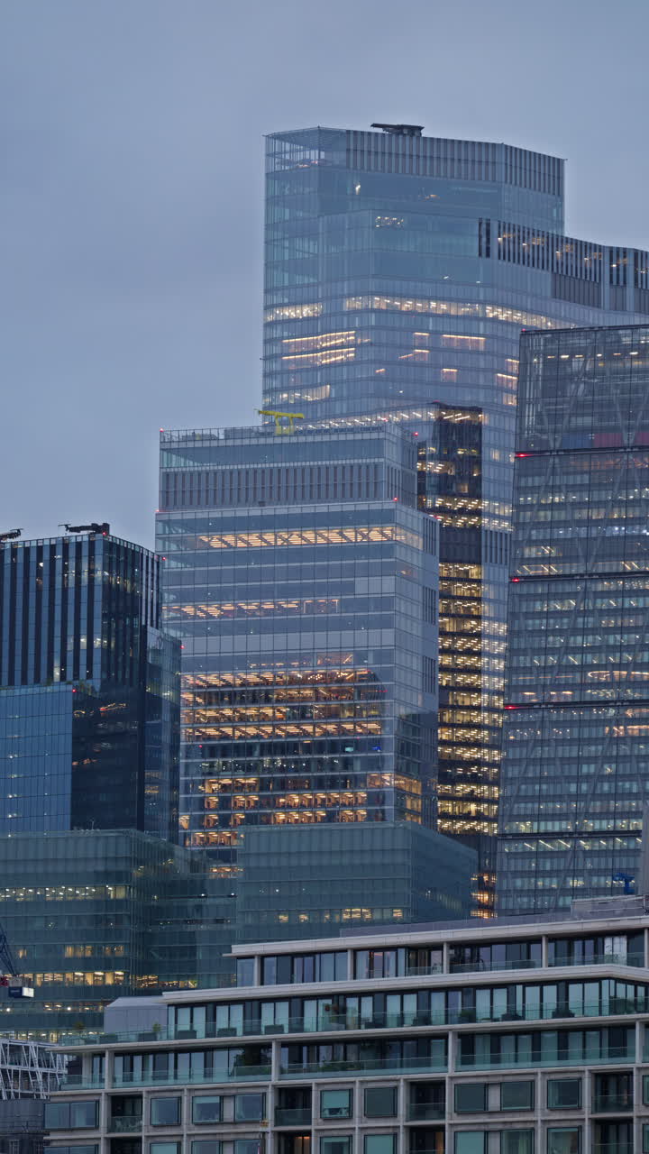 View of a modern glass office buildings in London, England in the evening. Vertical