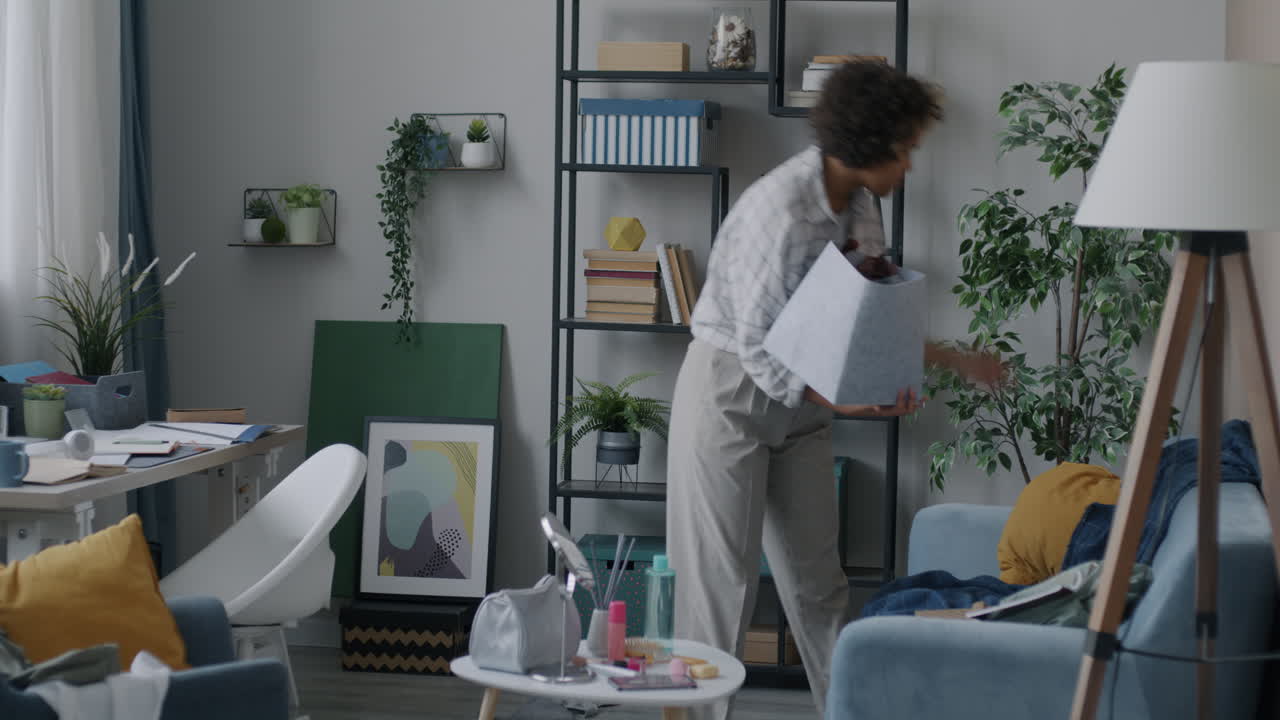 Woman Cleaning and Organizing a Living Room