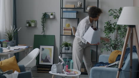 woman cleaning and organizing a living room