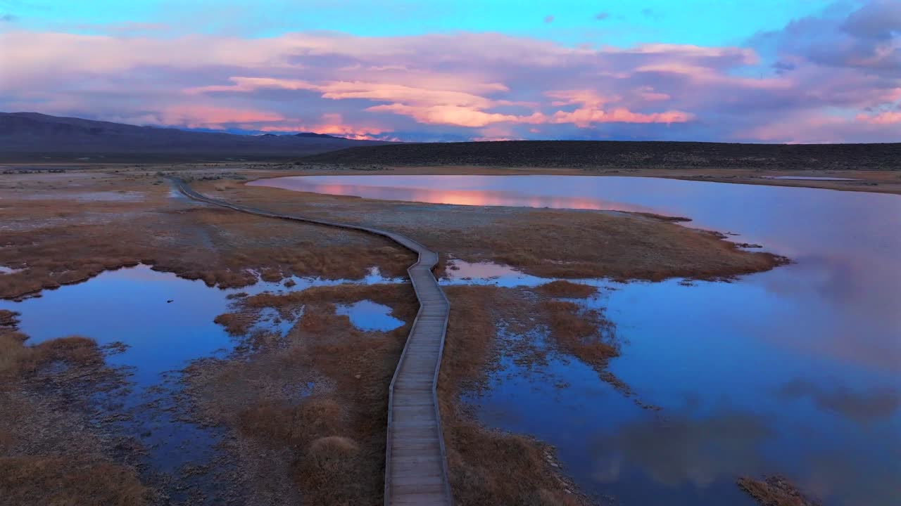 Boardwalk Hilltop Wild Willy's Hot Springs Mammoth Lakes California aerial drone winter vibrant sunset clouds Benton Crossing Lake Crowley Long Valley Caldera valley birds flying forward pan up motion