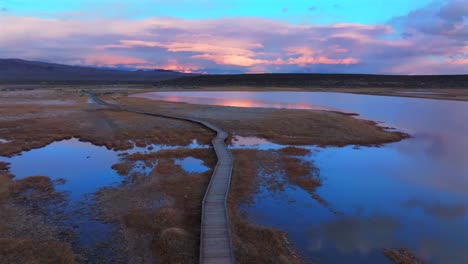 boardwalk hilltop wild willy's hot springs mammoth lakes california aerial drone winter vibrant sunset clouds benton crossing lake crowley long valley caldera valley birds flying forward pan up motion
