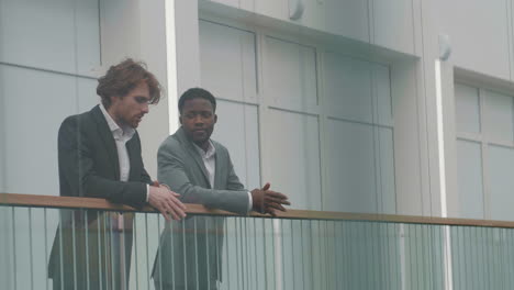 two businessmen communicating in office hall