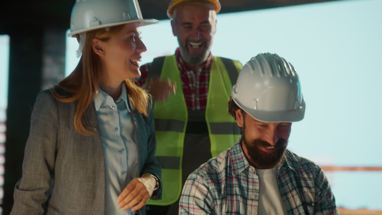 Construction Engineers Collaborating and Laughing on Site