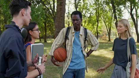 group of friends talking in a park