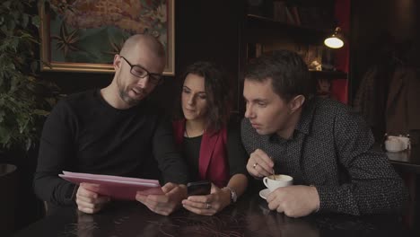 three people meeting in a cafe