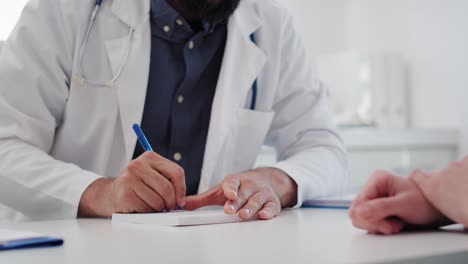 handheld view of doctor writing a prescription