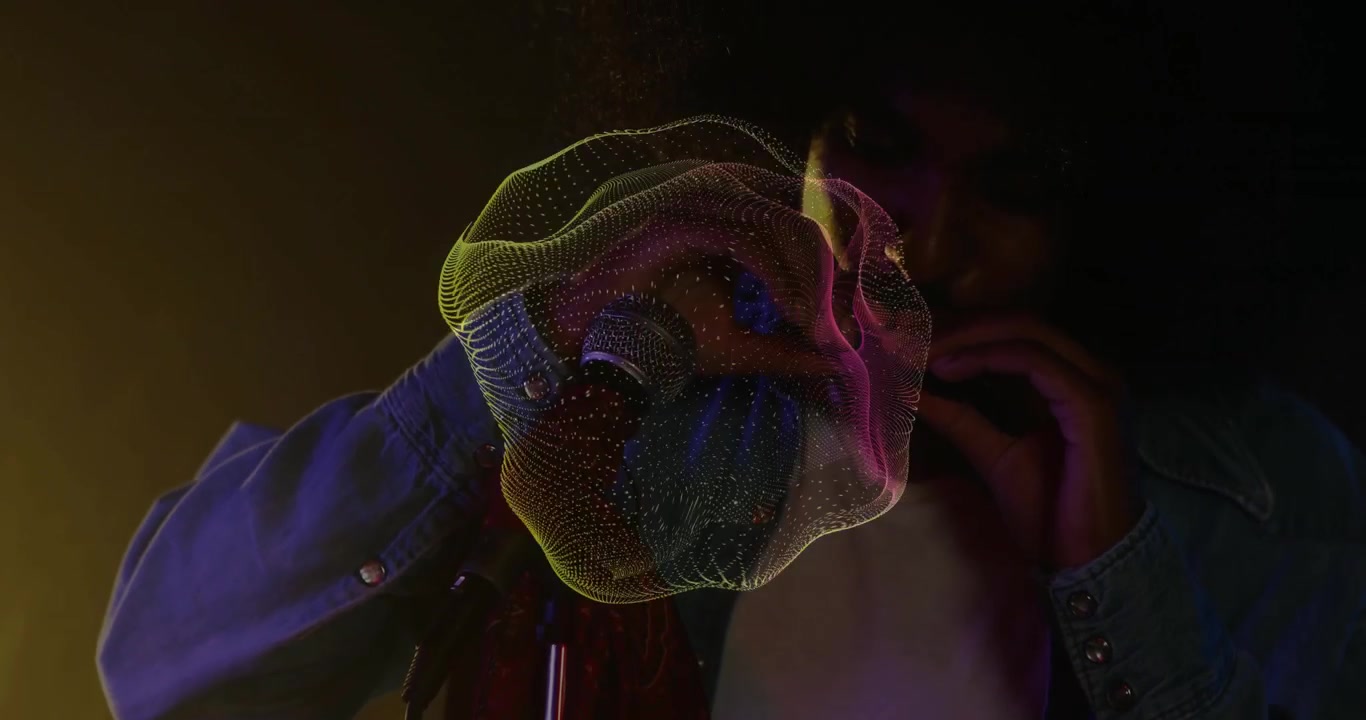 Musician leaning into mic playing harmonica creating pulsing waveform under amber violet glow