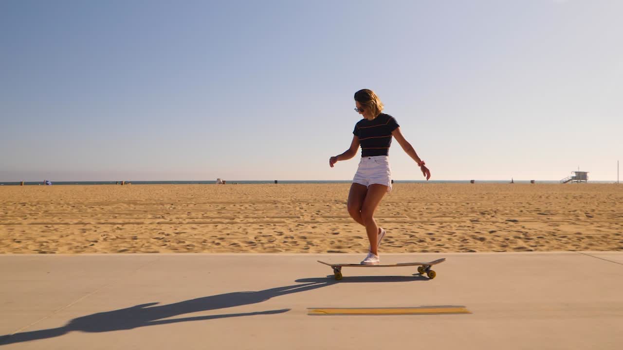 Cheerful Skater Woman Dancing While Riding Her Longboard Skateboard On A Desert Park