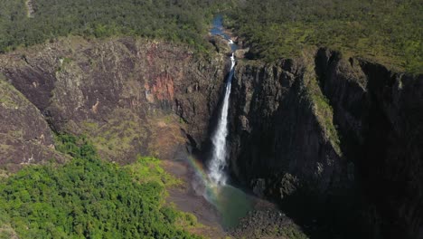 Beautiful-tall-waterfall-cascading-over-canyon,-4K-aerial-landscape