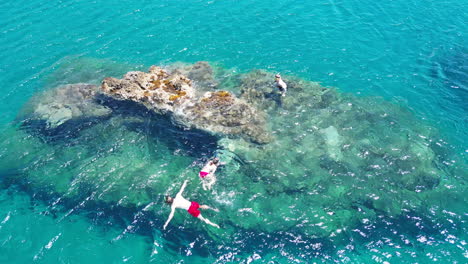 aerial view of young scuba diver swimming around