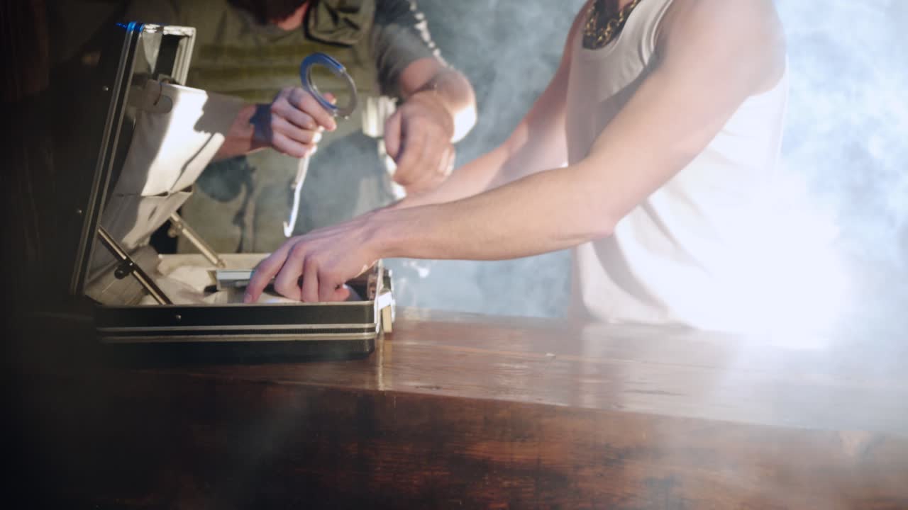 policeman are putting handcuffs on a drug dealer. Criminal in handcuffs. Illegal drug trafficking