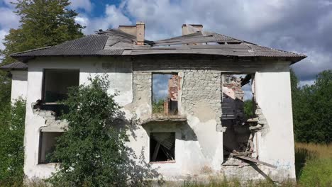 Close-drone-video-of-the-roofless-abandoned-house-with-old-chimneys