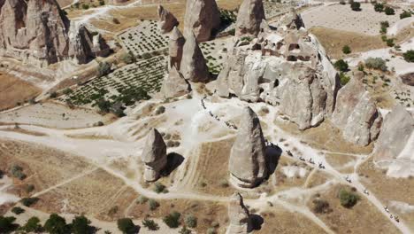 riders with horses walking through the tufa landscape of the unesco world heritage site goreme, cappadocia, central anatolia, turkey, asia