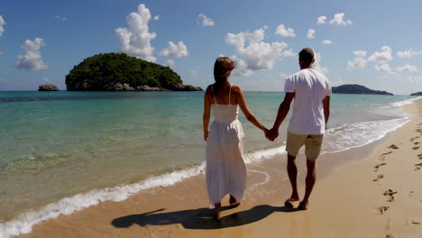 couple walking on a tropical beach