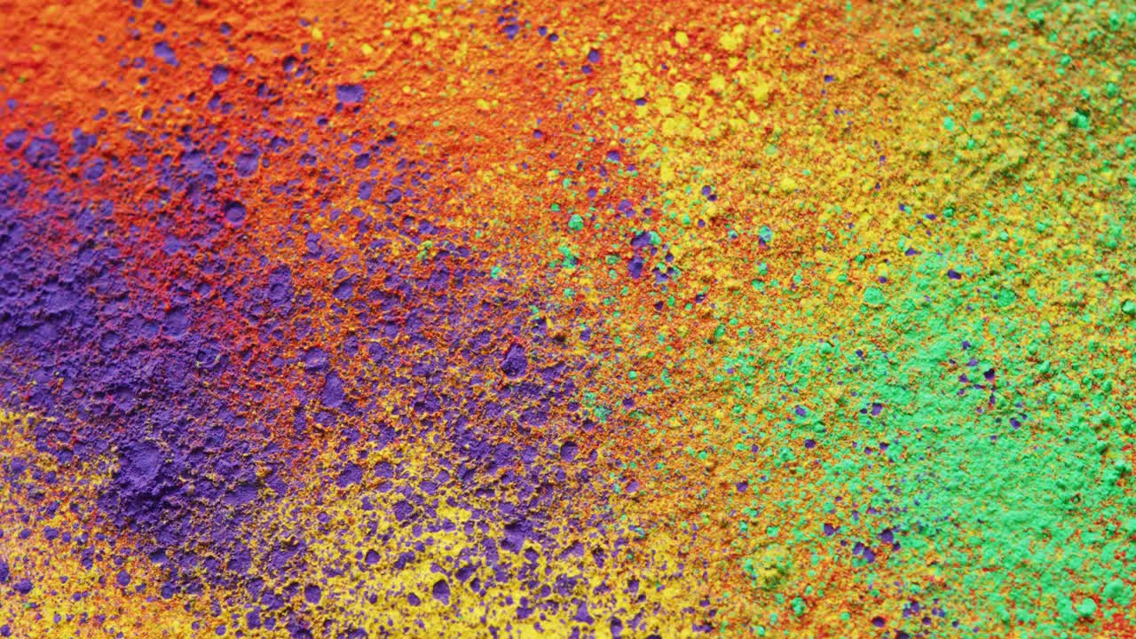 Video of close up of multi coloured powders with copy space