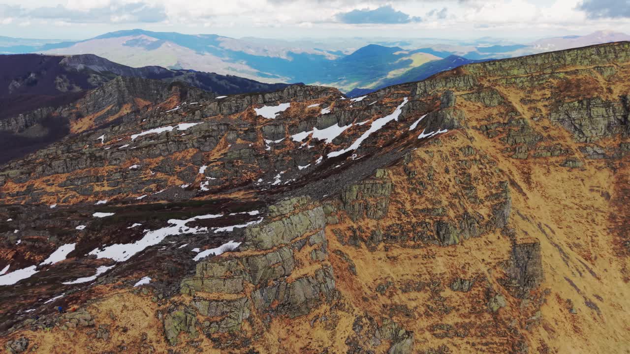 The dolomites mountains, showcasing rugged rock formations and snow, aerial view