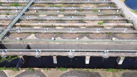 Aerial-top-view-of-circular-ponds-in-wastewater-treatment-plant-and-filtration-of-dirty-sewage-water