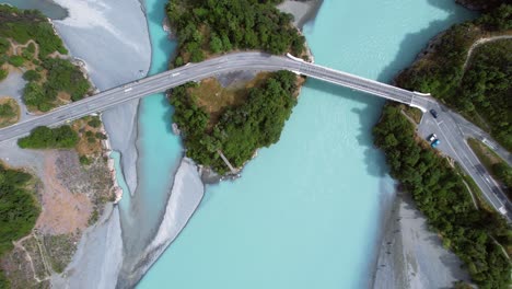 aerial view of traffic driving across a bridge on the rakaia river, new zealand