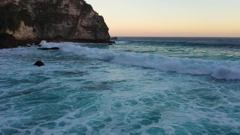 aerial view of turquoise ocean waves crashing coastline of nusa penida island, one of the tourist attractions of bali island crystal beach kelingking beach angle billabong broken beach