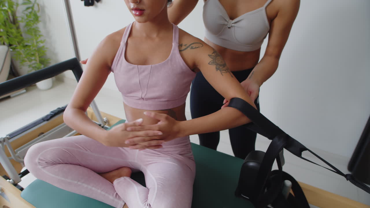 Woman Stretching Body Muscles with Resistance Bend with Trainer