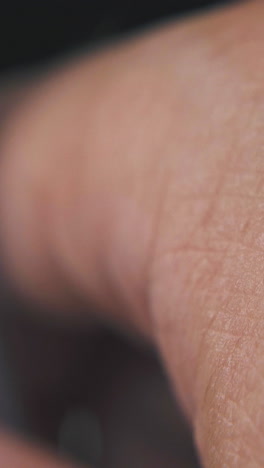 mature man taps with new ball pen in transparent case on blurry background extreme close view