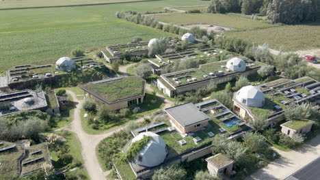 flying over earthships in green community