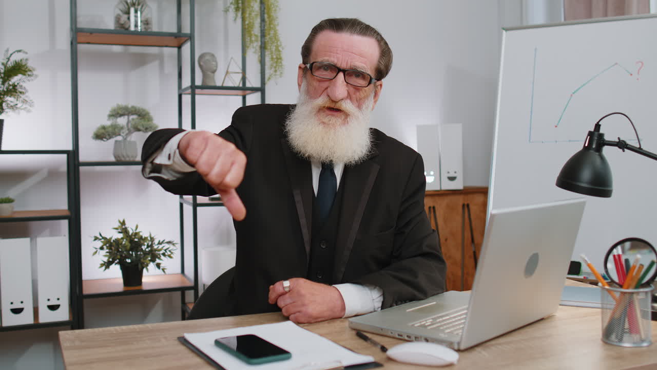 Upset businessman showing thumbs down, dislike bad work, disapproval dissatisfied feedback at office