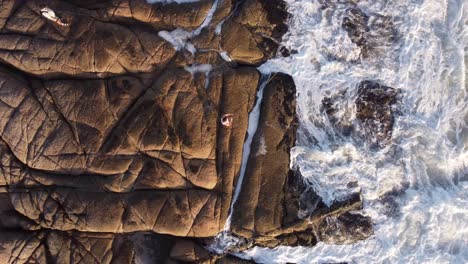 Fishermen-Fishing-On-Rocky-Cliff-Of-Punta-Del-Diablopunta-Del-Diablo,-Uruguay