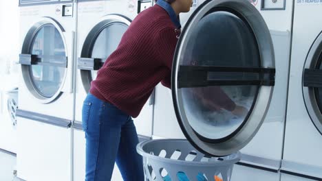 Woman-removing-clothes-from-washing-machine-4k