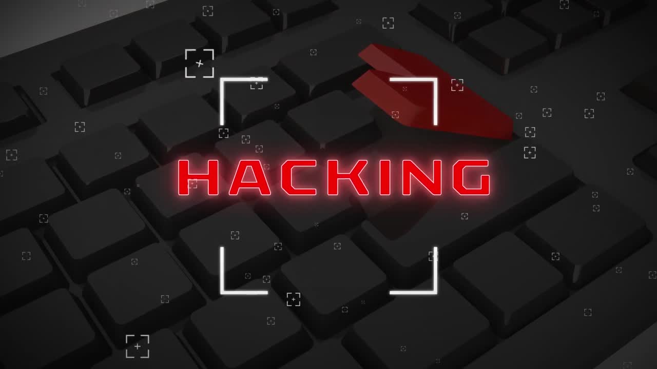 The word 'hacking' is written on a computer screen in red, against a black background