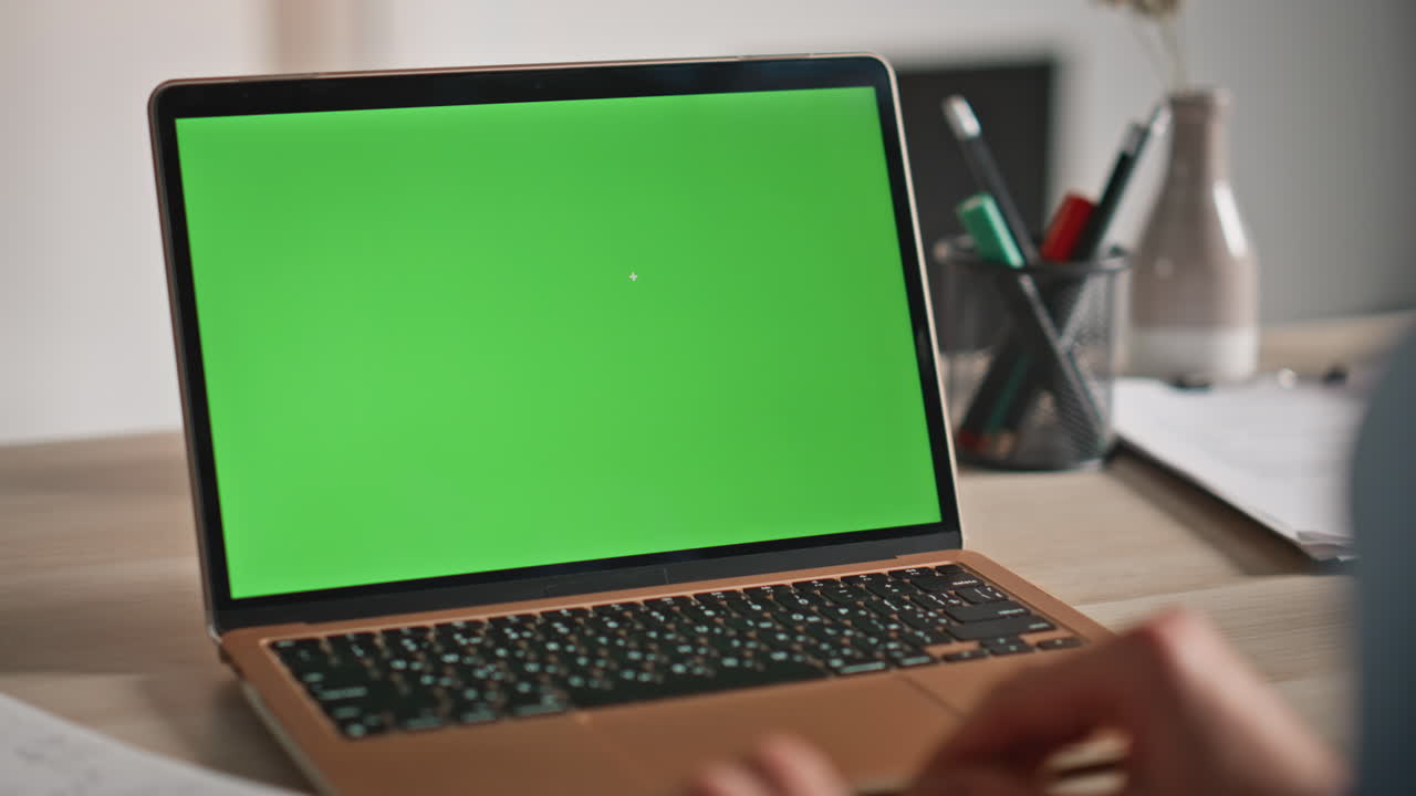 Businesswoman using mockup laptop for remote work at home workplace closeup