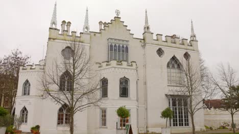 white gothic revival architecture of strawberry hill house in london on a cloudy day, exterior shot