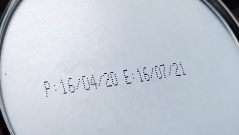 Hand-of-a-man-hold-tinned-canned-food-upside-down-to-reveal-the-Packed-Date-and-Expiry-Date-or-Best-Before-Date-details-to-check-the-freshness-of-the-food